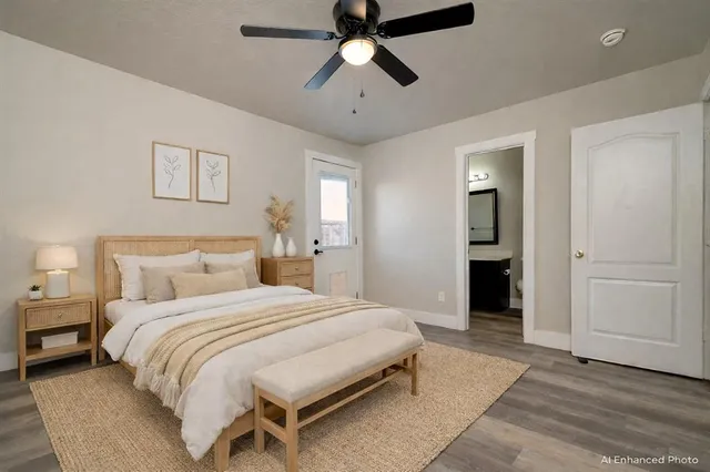 a spacious bedroom with a bed and a chandelier