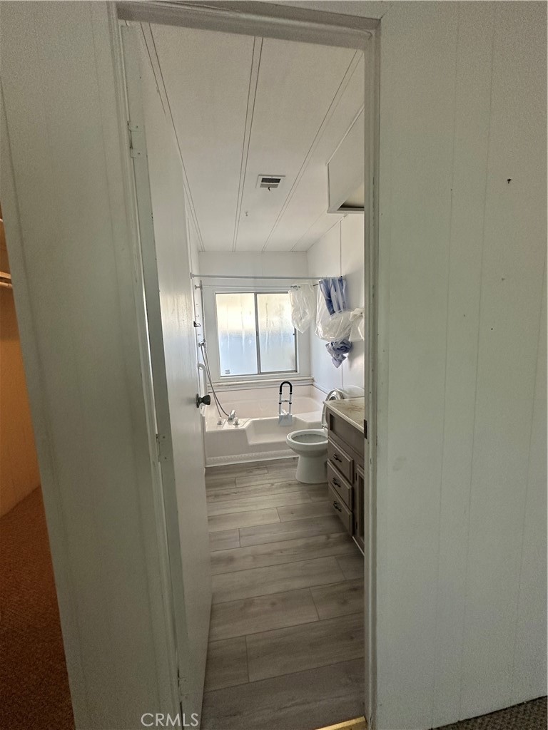 881 North Lake Street, Unit 301 Hemet, CA 92544 - Photo 12 of 21 a bathroom with a sink and mirror with bathtub