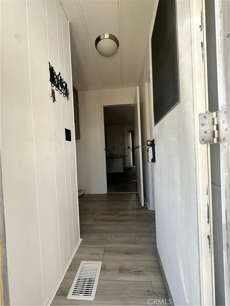 881 North Lake Street, Unit 301 Hemet, CA 92544 - Photo 18 of 21 a view of a hallway with wooden floor and staircase