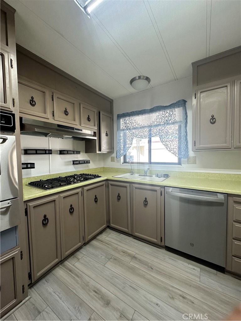 881 North Lake Street, Unit 301 Hemet, CA 92544 - Photo 6 of 21 a kitchen with appliances cabinets and a sink