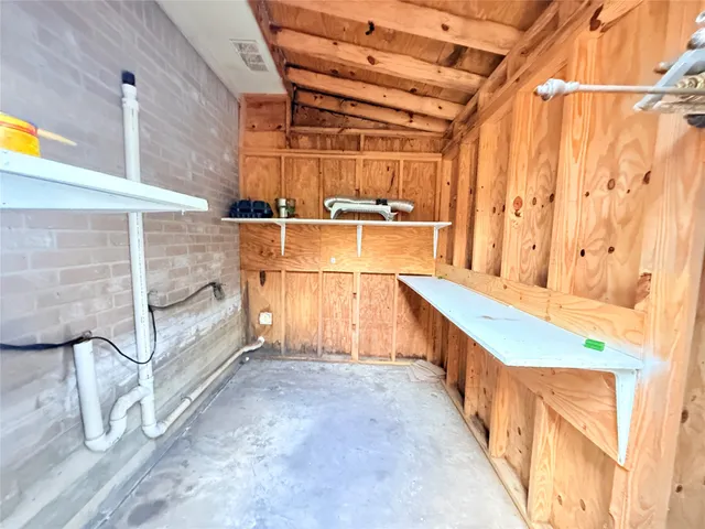 a view of a yard with plants and trees