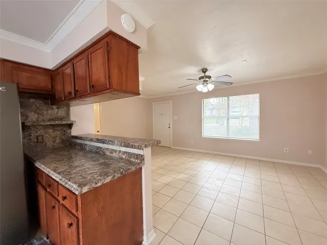 an empty room with windows and cabinet