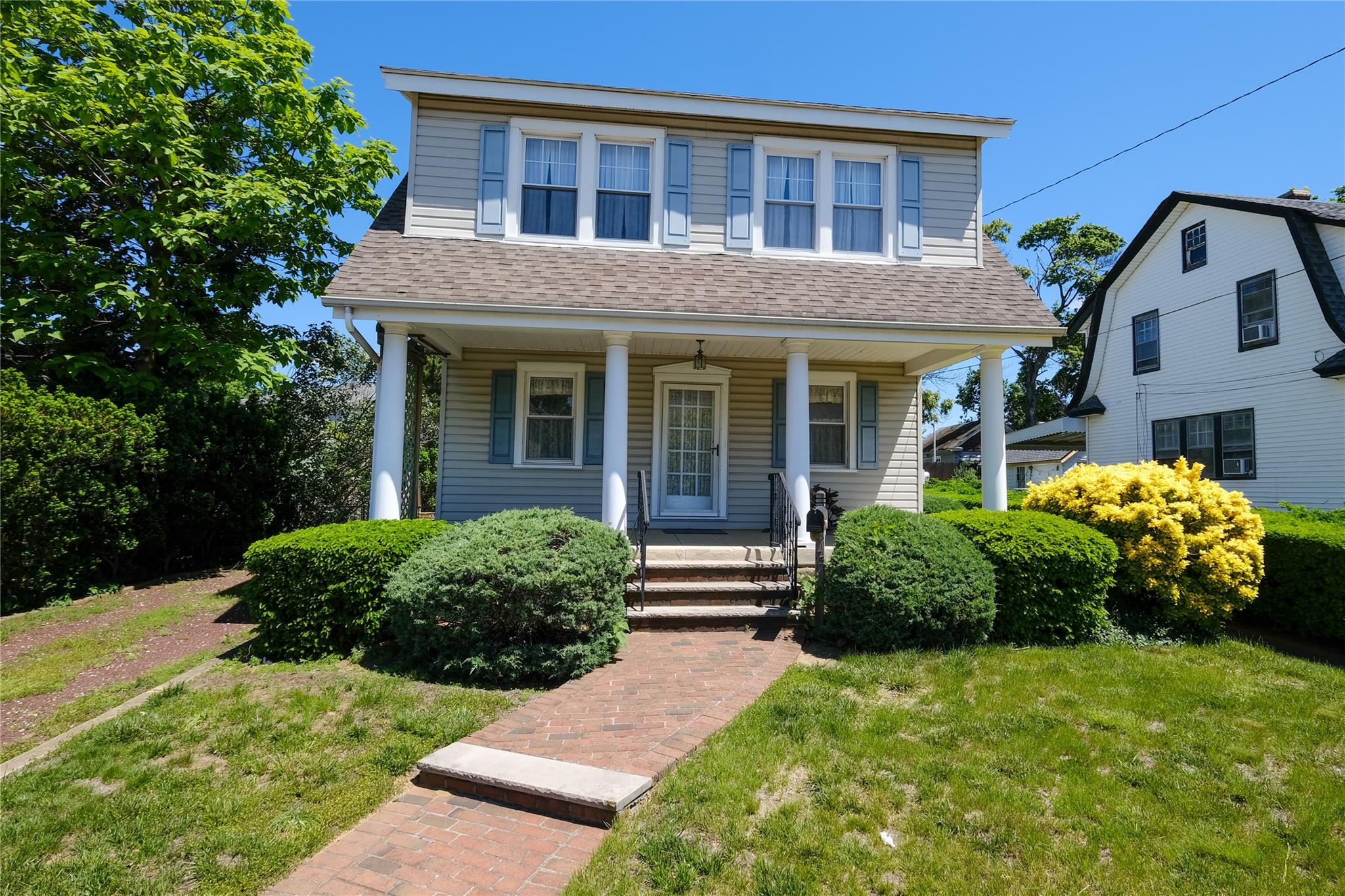 a front view of a house with garden