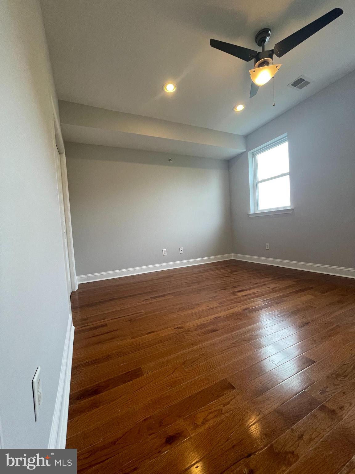 2510 Federal Street, Unit 2 Philadelphia, PA 19146 - Photo 13 of 22 an empty room with wooden floor and windows