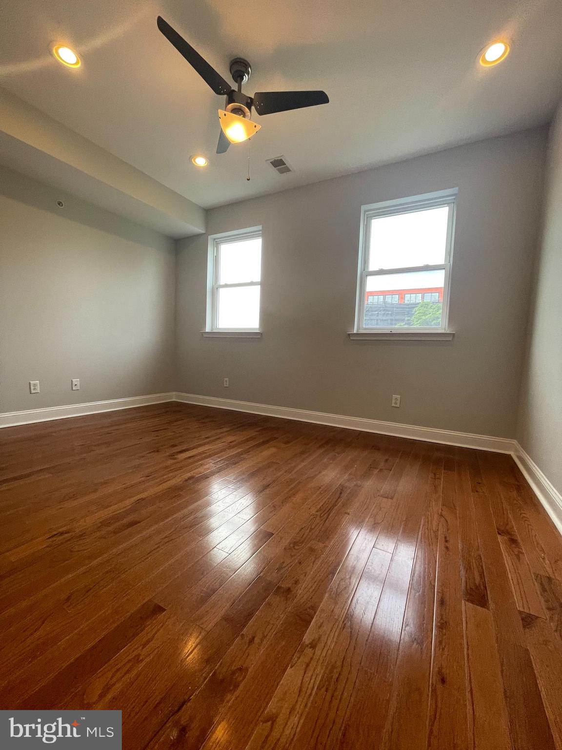 2510 Federal Street, Unit 2 Philadelphia, PA 19146 - Photo 14 of 22 an empty room with wooden floor and windows
