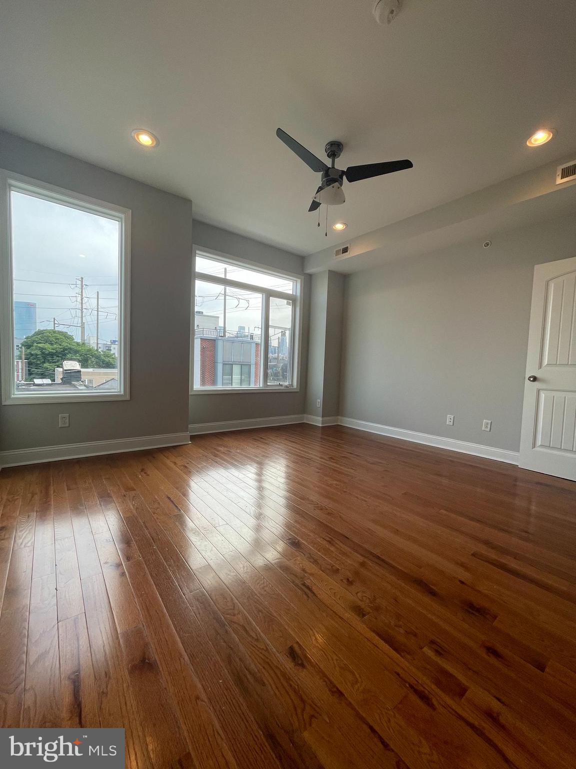 2510 Federal Street, Unit 2 Philadelphia, PA 19146 - Photo 16 of 22 a view of an empty room with wooden floor and a window