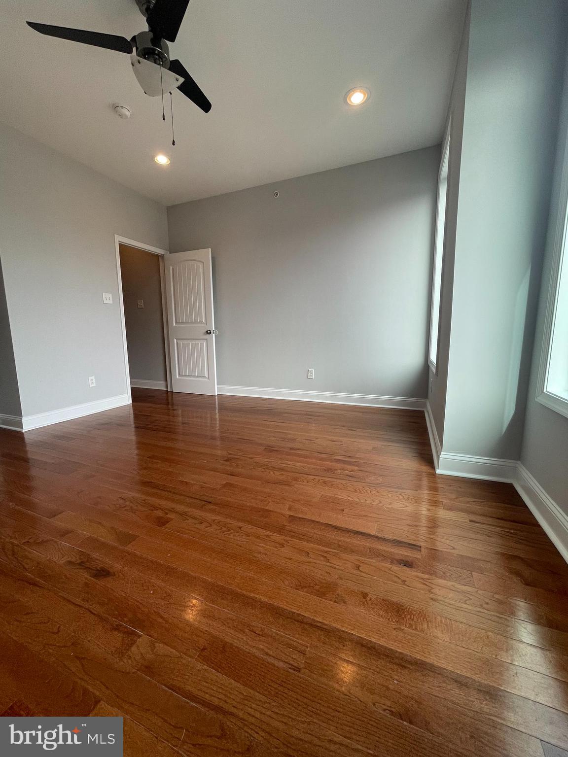 2510 Federal Street, Unit 2 Philadelphia, PA 19146 - Photo 18 of 22 a view of an empty room with a window and wooden floor