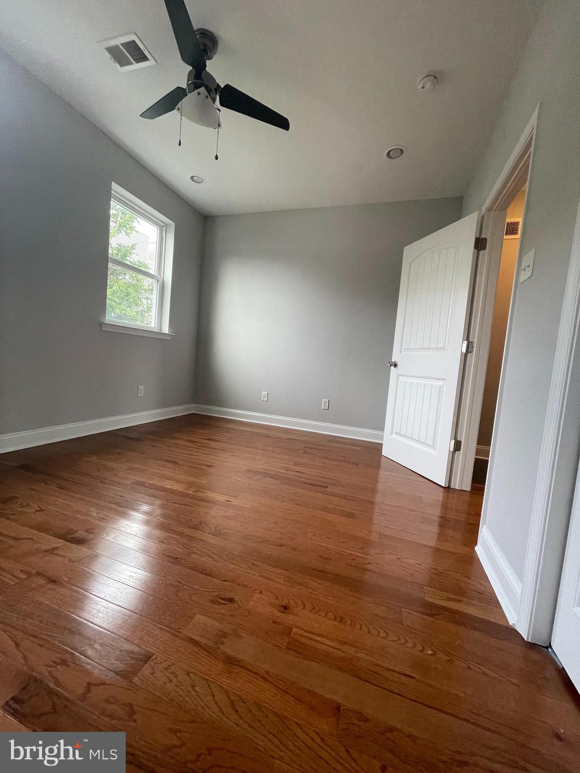 2510 Federal Street, Unit 2 Philadelphia, PA 19146 - Photo 6 of 22 an empty room with wooden floor and windows