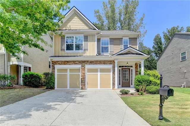 a front view of a house with a yard and garage