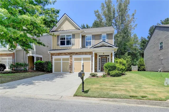 a front view of a house with a yard and garage