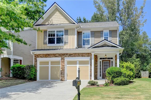 a front view of a house with a yard and garage