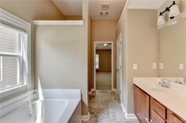 a bathroom with a tub sink and shower