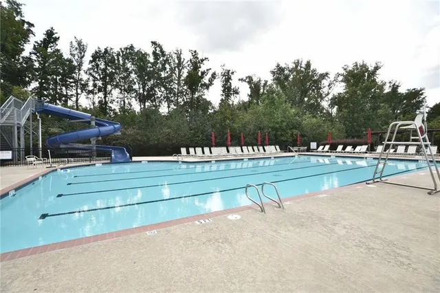 a view of swimming pool with chairs