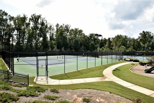 a view of sign board with buildings in the background