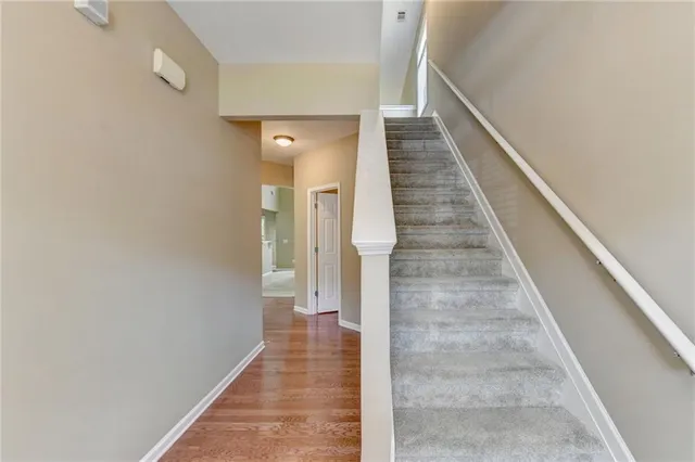 a view of a hallway with wooden floor and entryway