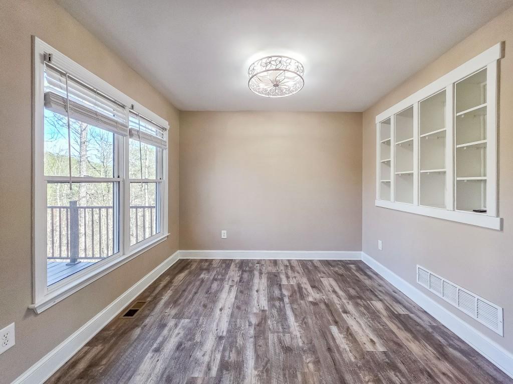 165 Horseshoe Bend Jasper, GA 30143 - Photo 11 of 44 a view of empty room with wooden floor and fan