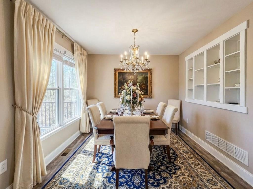 165 Horseshoe Bend Jasper, GA 30143 - Photo 12 of 44 a dining room with chandelier and wooden floor