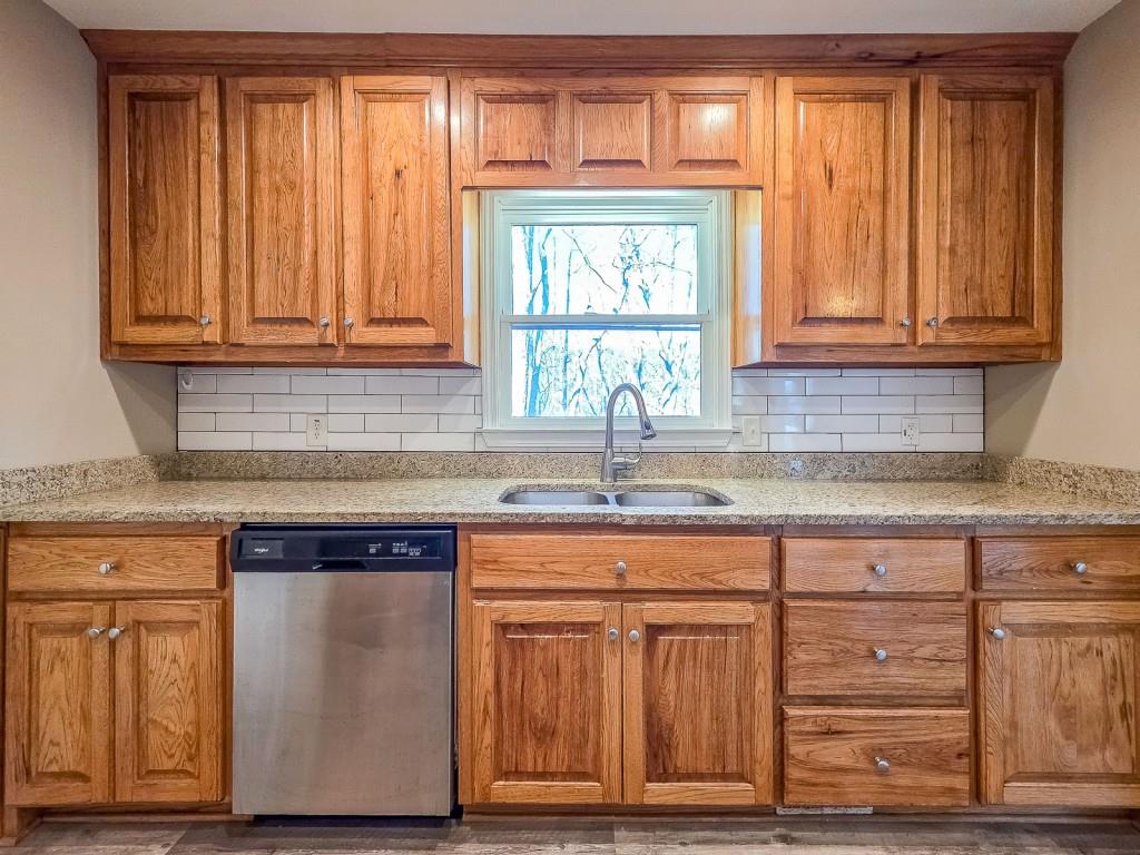 165 Horseshoe Bend Jasper, GA 30143 - Photo 16 of 44 a kitchen with granite countertop wooden cabinets and a sink
