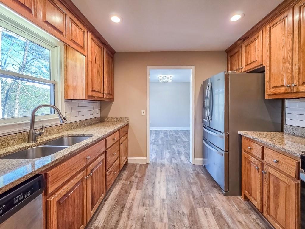 165 Horseshoe Bend Jasper, GA 30143 - Photo 18 of 44 a kitchen with stainless steel appliances granite countertop a sink stove and refrigerator