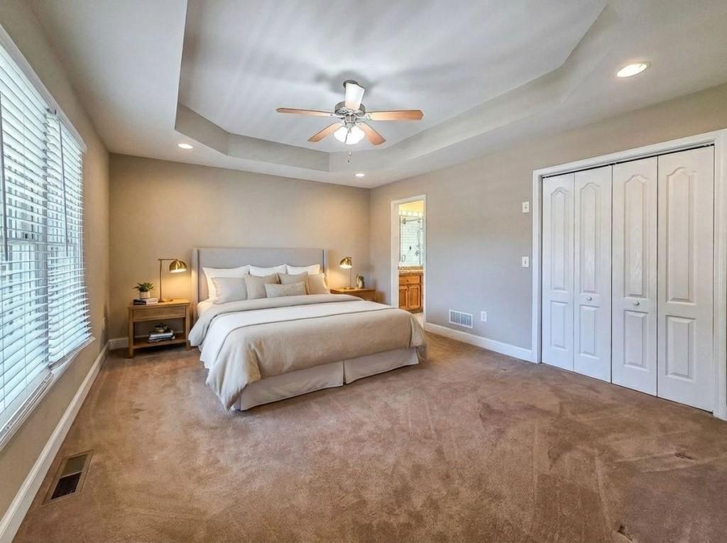 165 Horseshoe Bend Jasper, GA 30143 - Photo 19 of 44 a spacious bedroom with a bed and a ceiling fan