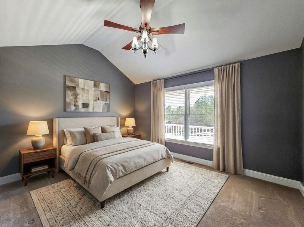 165 Horseshoe Bend Jasper, GA 30143 - Photo 24 of 44 a bedroom with a large bed and a chandelier fan