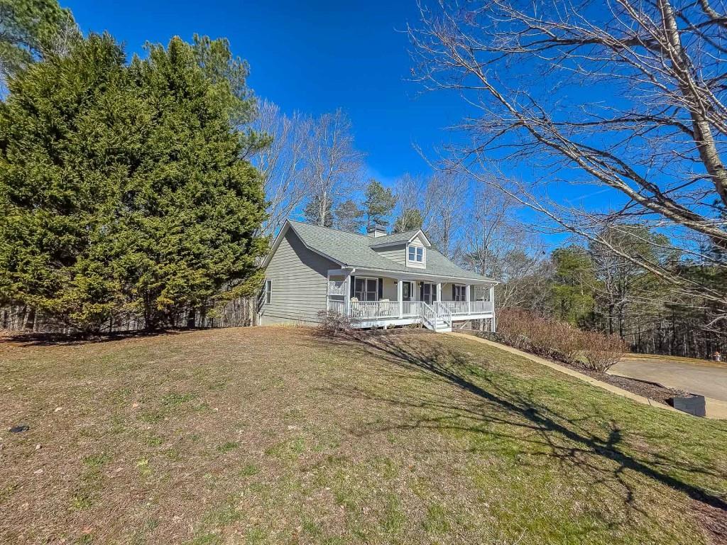 165 Horseshoe Bend Jasper, GA 30143 - Photo 5 of 44 a big house with tall trees in the background