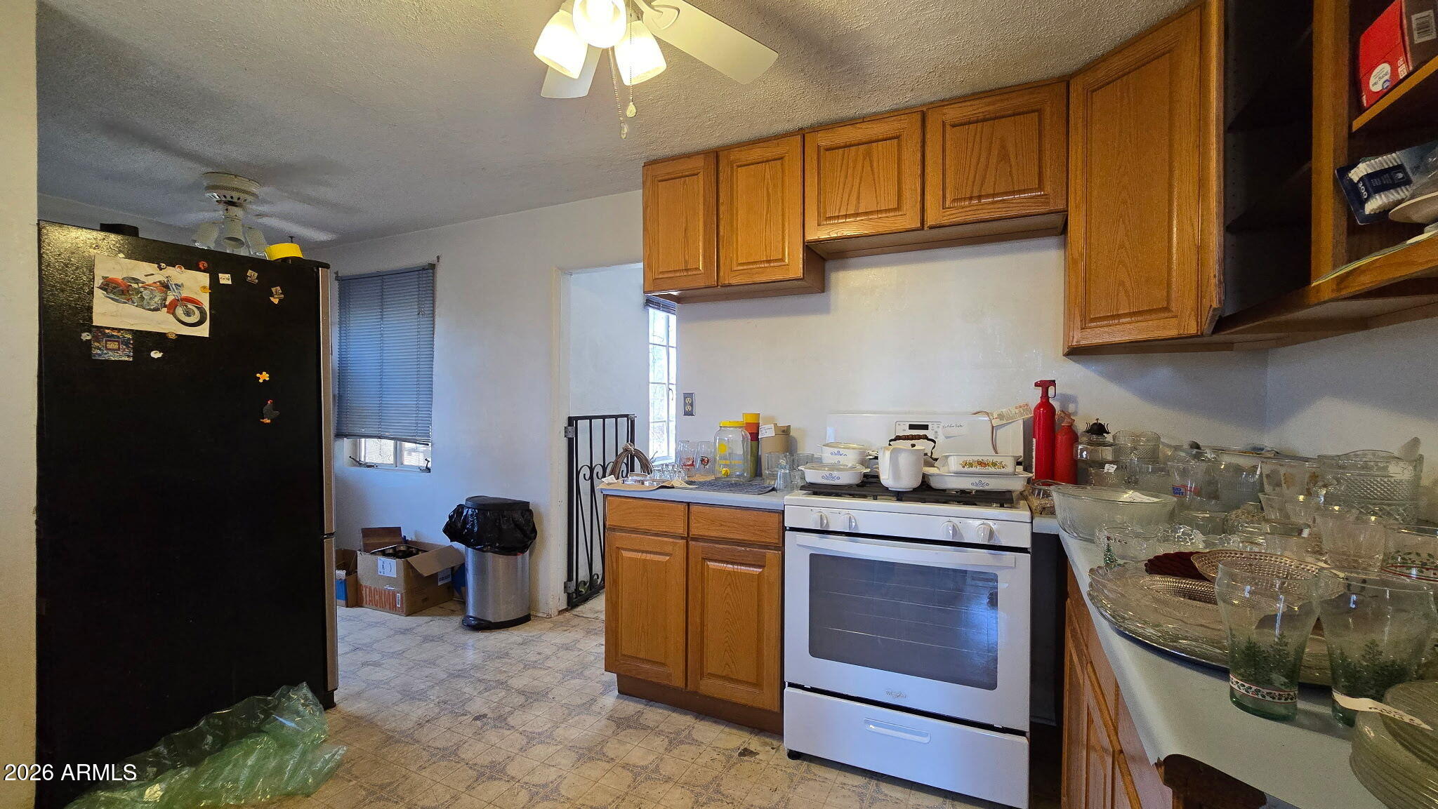 6803 South Miller Road Buckeye, AZ 85326 - Photo 8 of 50 a kitchen with stainless steel appliances granite countertop a sink stove and cabinets