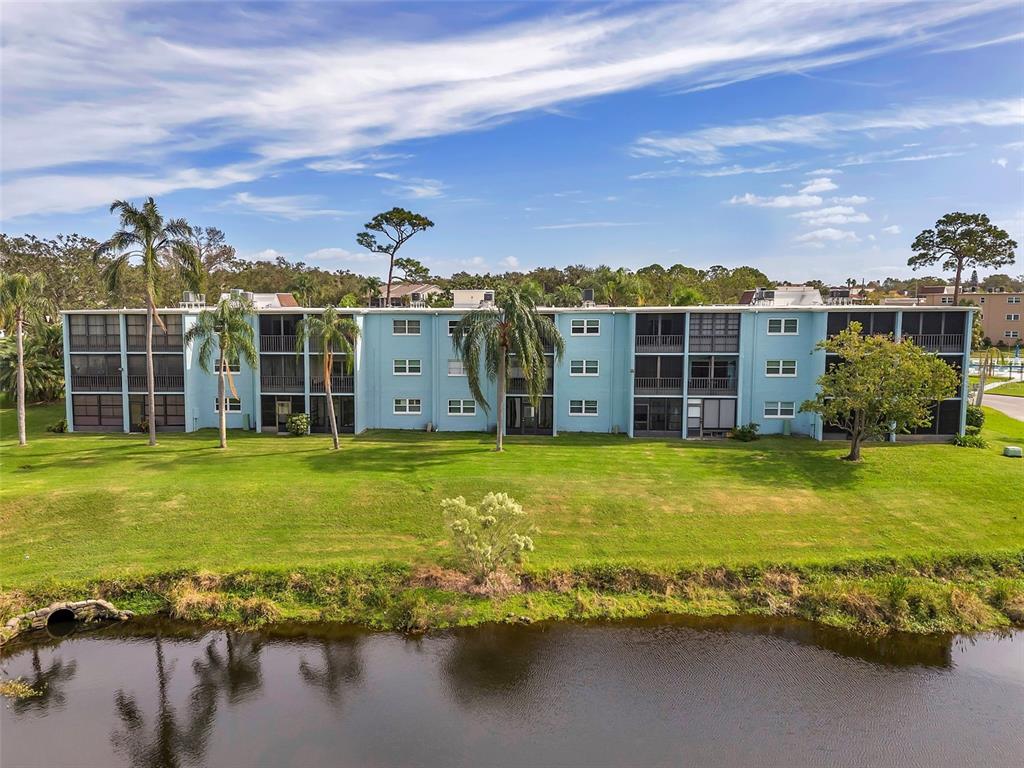1430 Heather Ridge Boulevard, Unit 304 Dunedin, FL 34698 - Photo 33 of 36 a view of a house with a yard