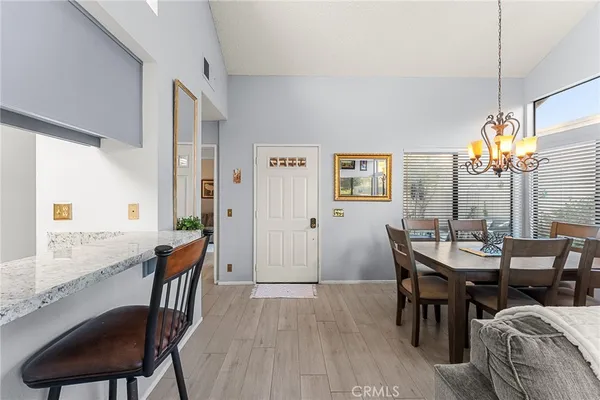 a living room with furniture a large window and wooden floor