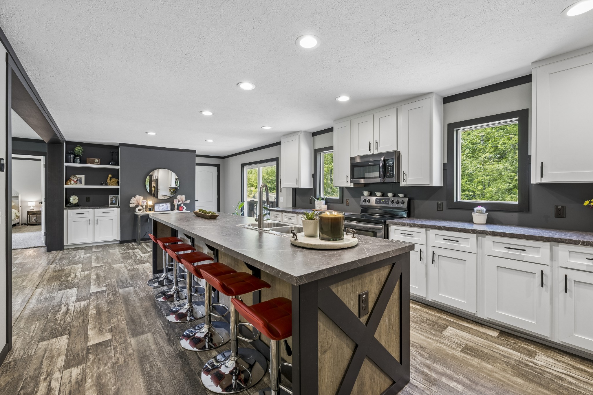 8079 Golf Club Road Mount Pleasant, TN 38474 - Photo 24 of 74 a kitchen with stainless steel appliances granite countertop a stove top oven a sink dishwasher a dining table and chairs with wooden floor