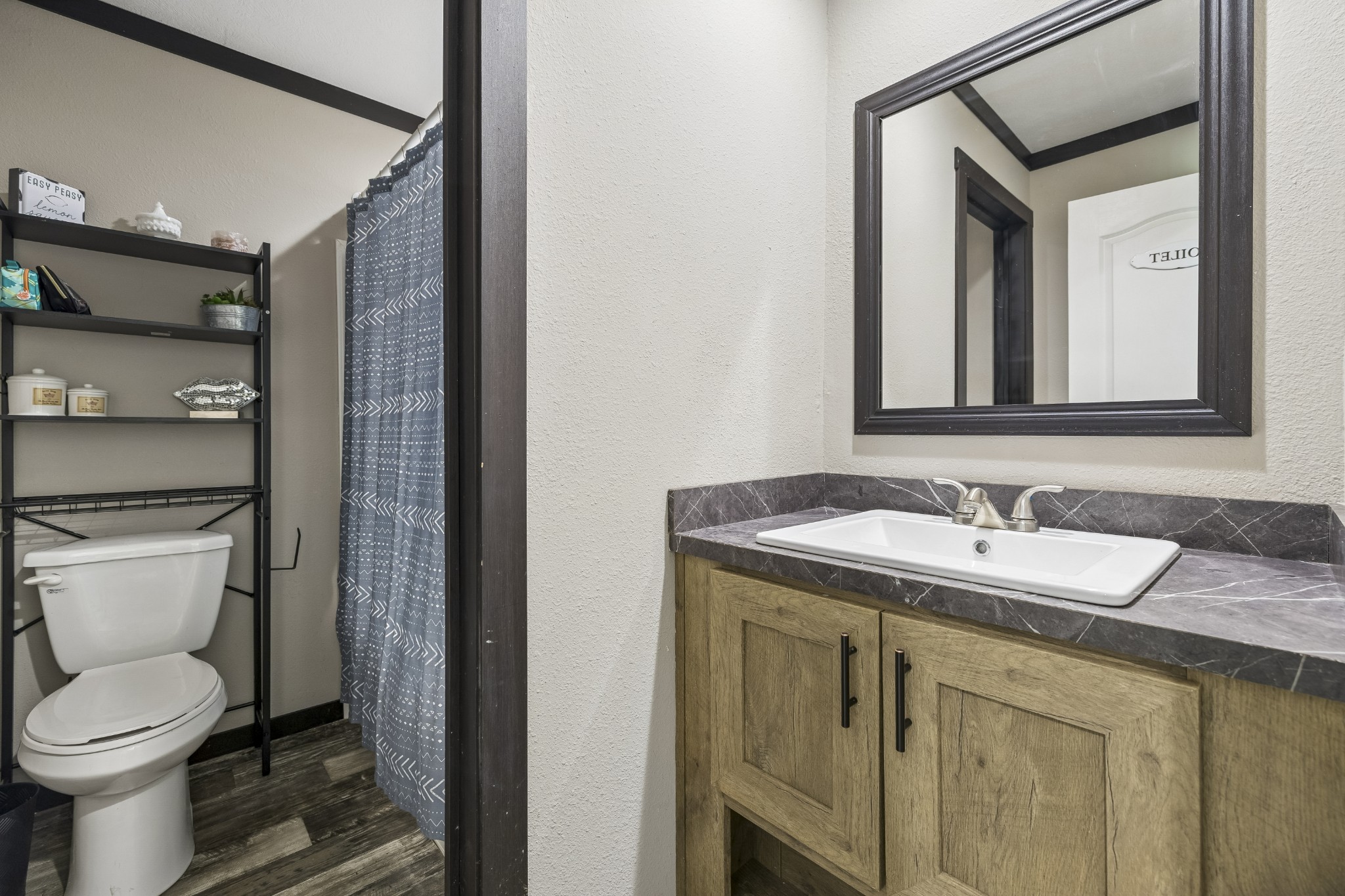 8079 Golf Club Road Mount Pleasant, TN 38474 - Photo 50 of 74 a bathroom with a granite countertop toilet sink and mirror