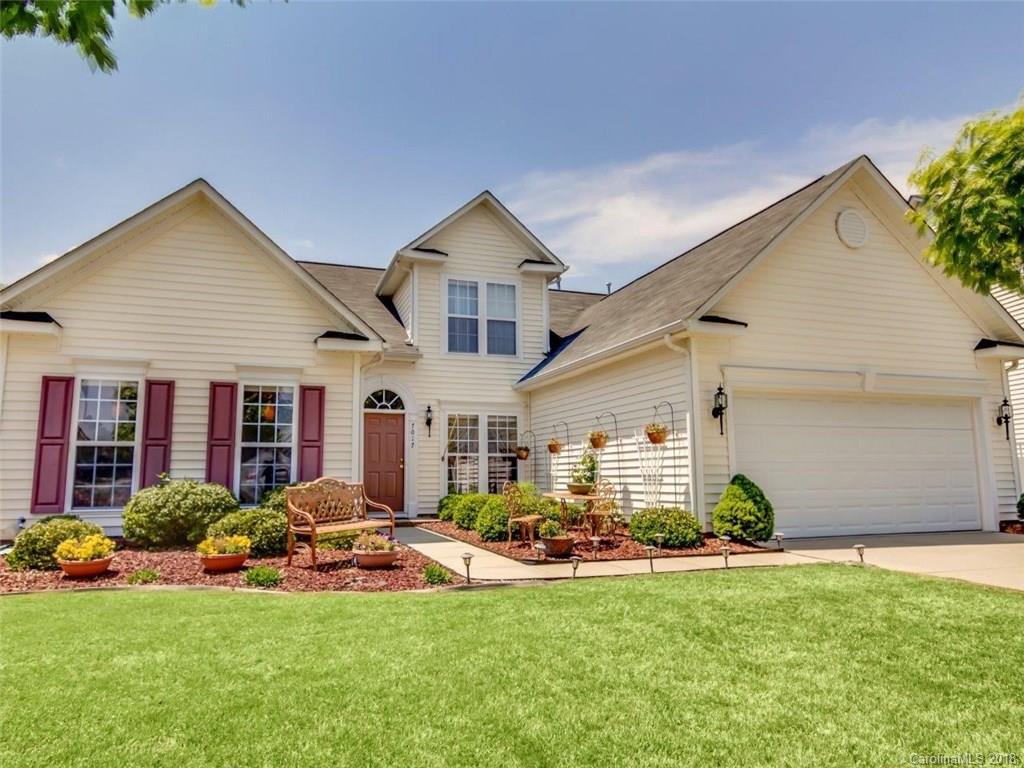 7017 Meyer Road Fort Mill, SC 29715 - Photo 1 of 26 a front view of a house with garden and porch
