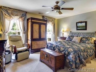 7017 Meyer Road Fort Mill, SC 29715 - Photo 11 of 26 a spacious bedroom with a bed a couch and a chandelier
