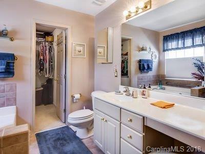 7017 Meyer Road Fort Mill, SC 29715 - Photo 14 of 26 a spacious bathroom with a sink a toilet a shower and a mirror