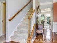 7017 Meyer Road Fort Mill, SC 29715 - Photo 3 of 26 a view of staircase with lots of frames and flower vase
