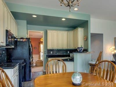 7017 Meyer Road Fort Mill, SC 29715 - Photo 8 of 26 a kitchen with sink a refrigerator and chairs