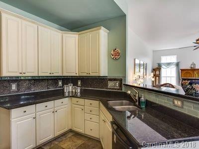 7017 Meyer Road Fort Mill, SC 29715 - Photo 9 of 26 a kitchen with granite countertop a sink stove and cabinets