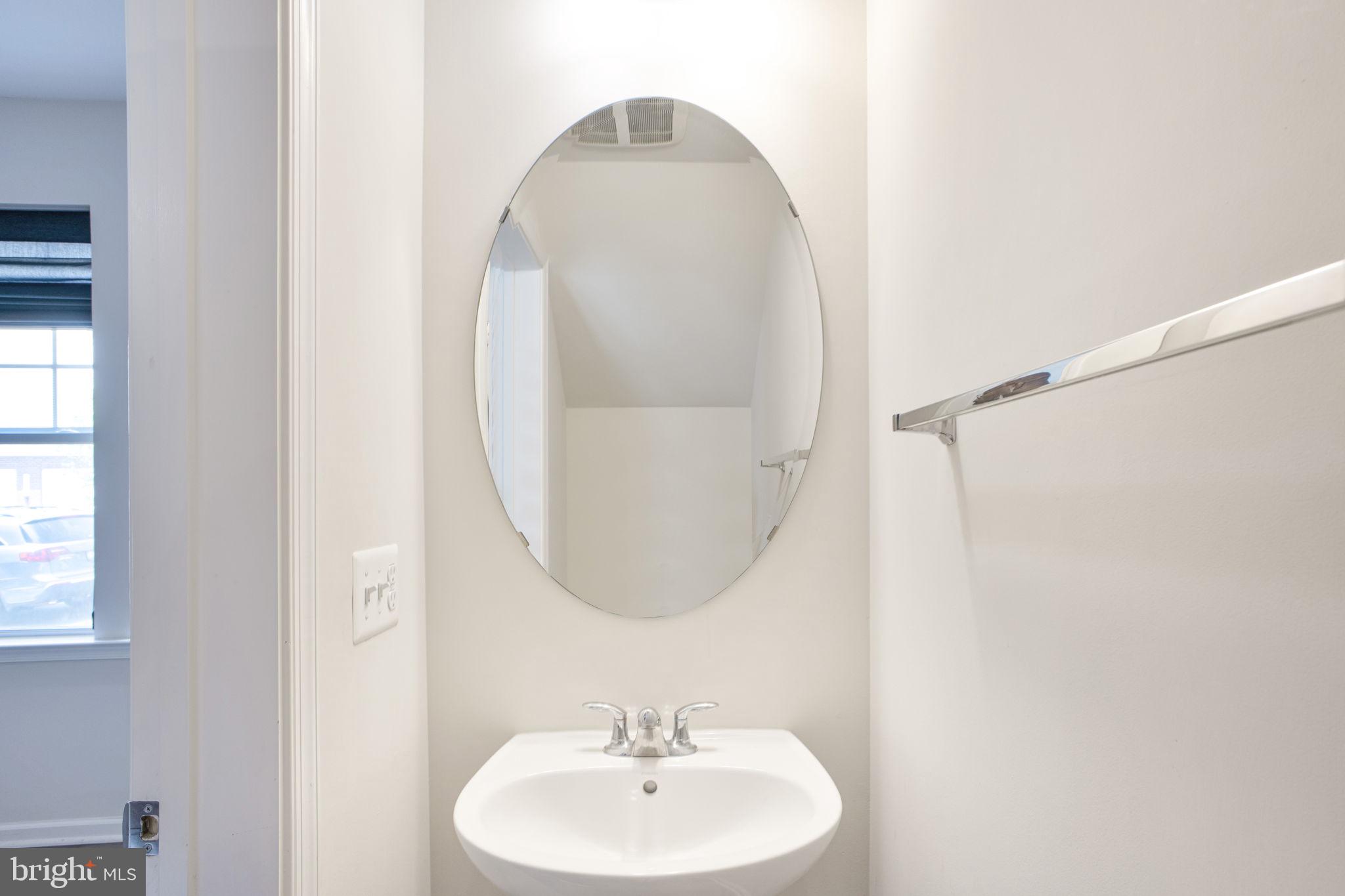 10517 Sally Ride Lane Lanham, MD 20706 - Photo 12 of 37 a bathroom with a sink and a mirror