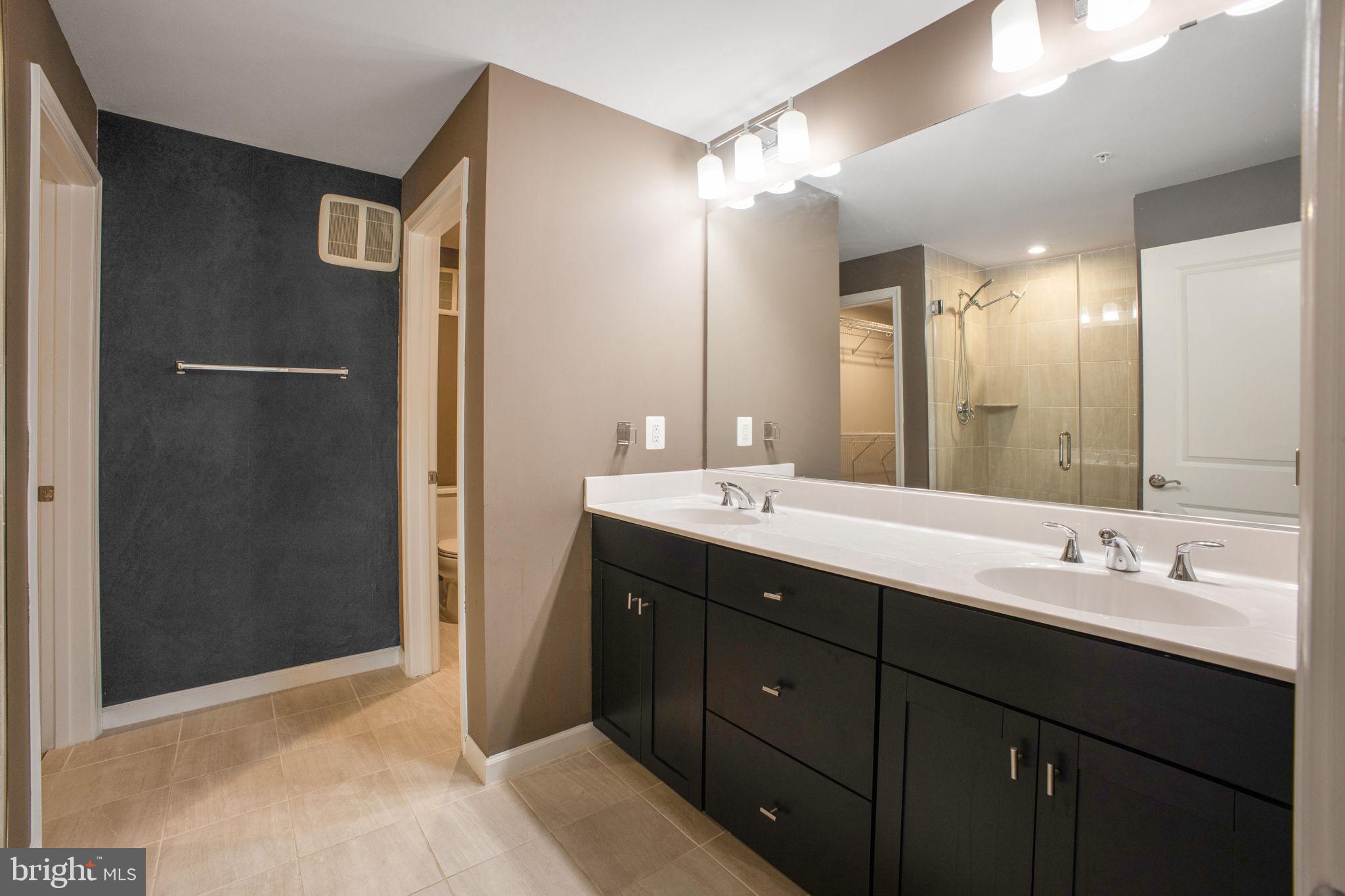 10517 Sally Ride Lane Lanham, MD 20706 - Photo 18 of 37 a bathroom with a double vanity sink and mirror