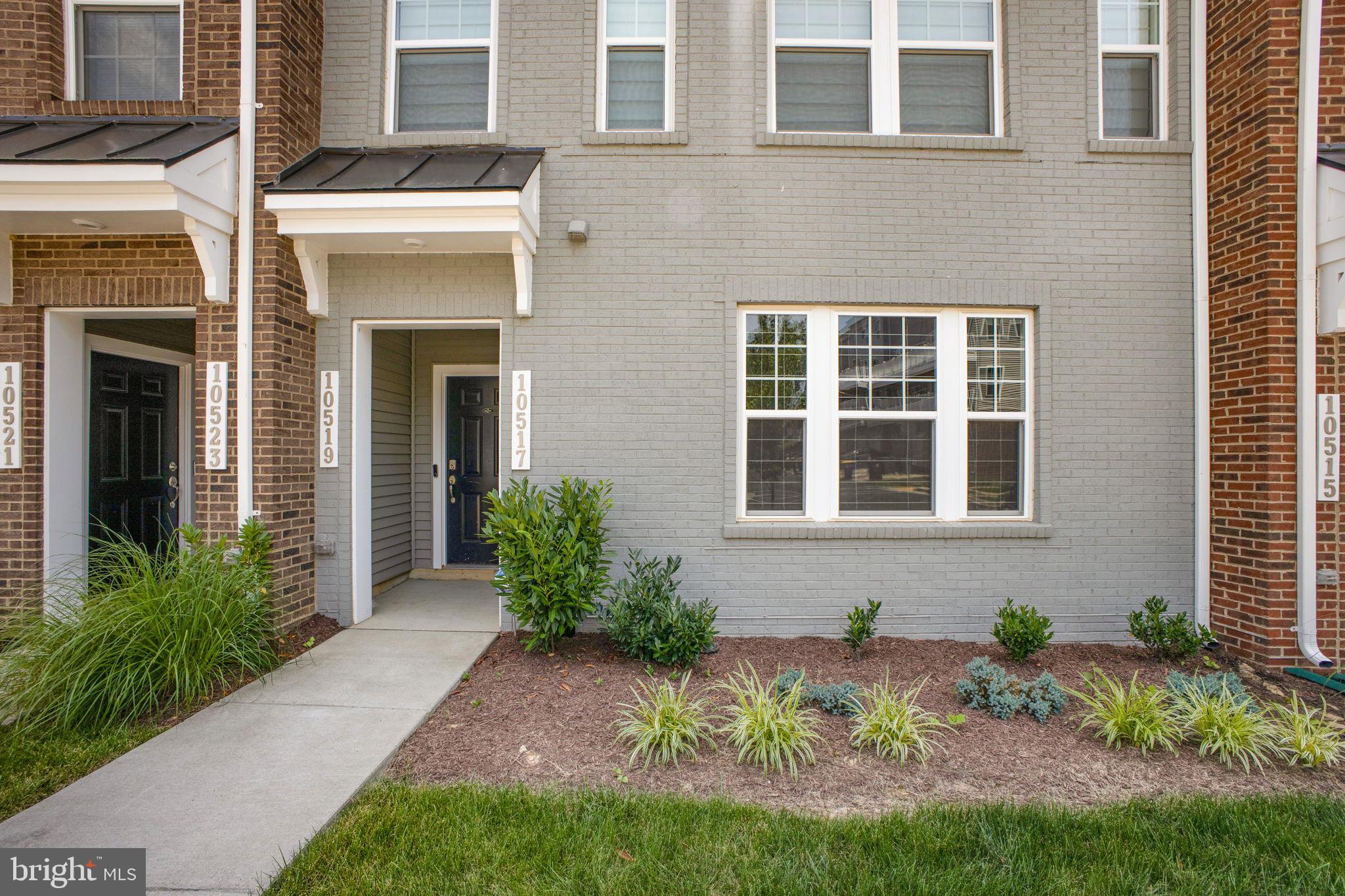 10517 Sally Ride Lane Lanham, MD 20706 - Photo 2 of 37 a front view of a house with a yard