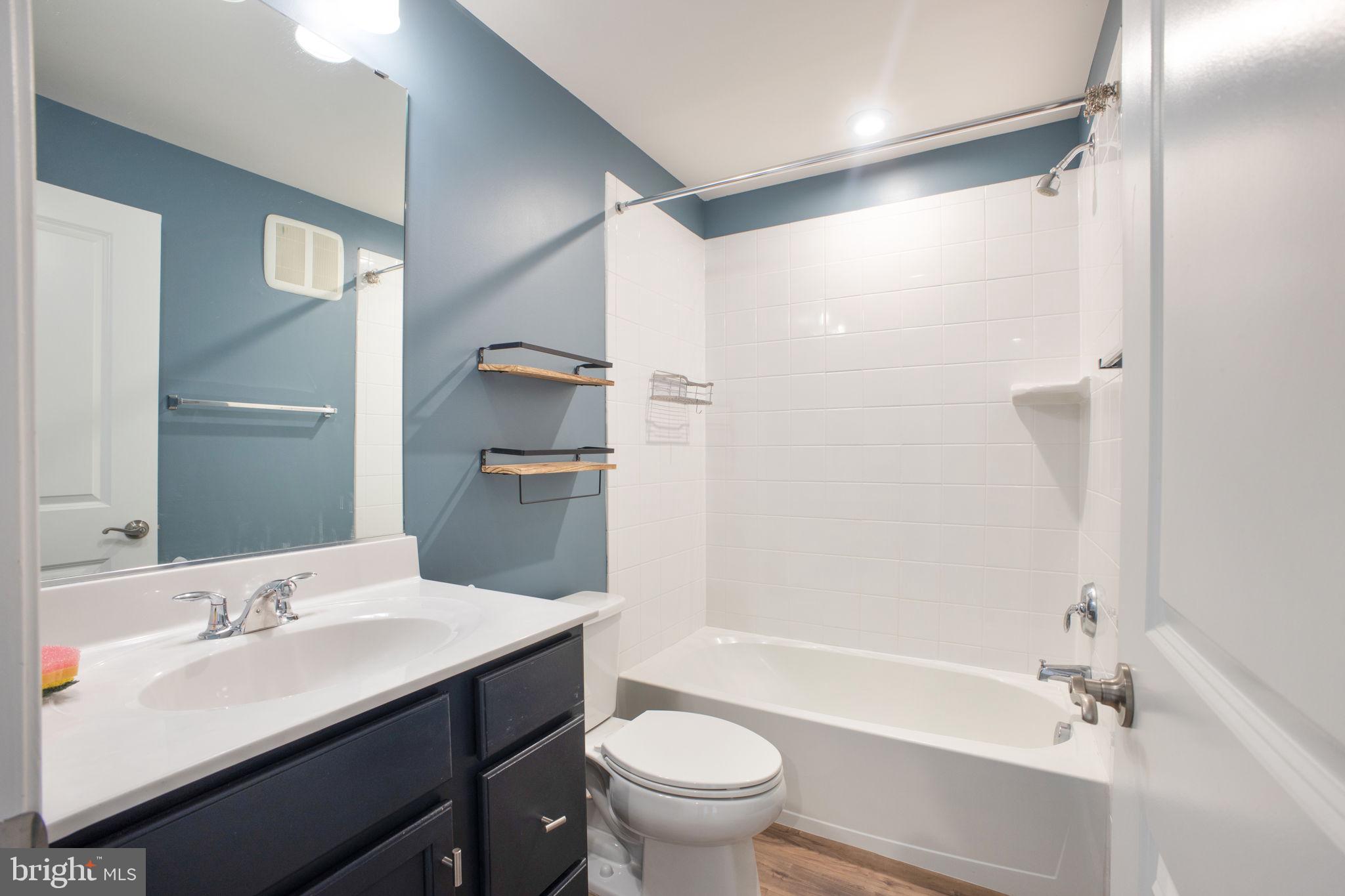 10517 Sally Ride Lane Lanham, MD 20706 - Photo 29 of 37 a bathroom with a sink a toilet and shower