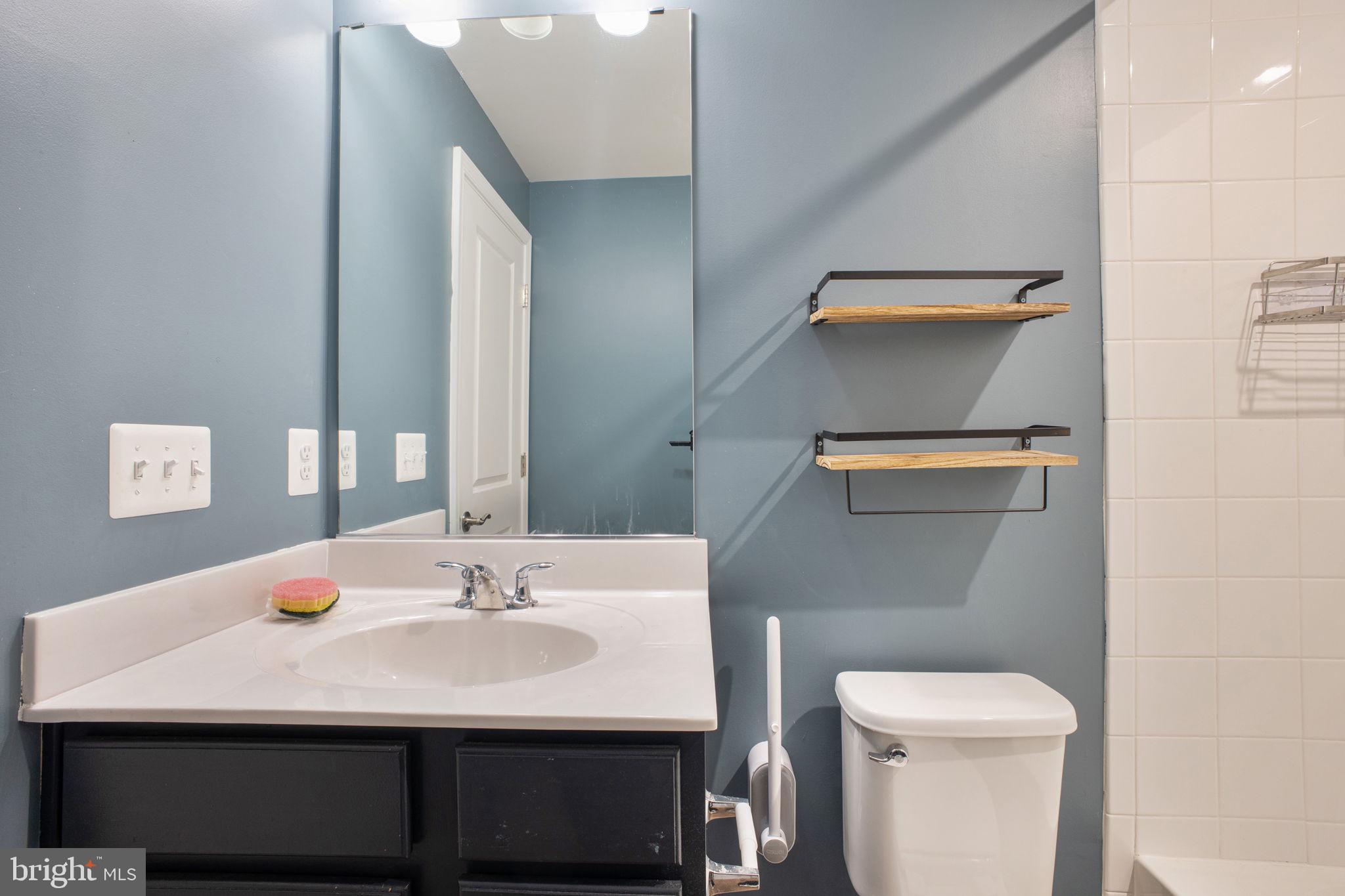 10517 Sally Ride Lane Lanham, MD 20706 - Photo 30 of 37 a bathroom with a sink a toilet and mirror