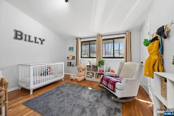 a living room with furniture gym equipment and a large window