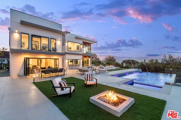 a view of a house with swimming pool and porch with furniture