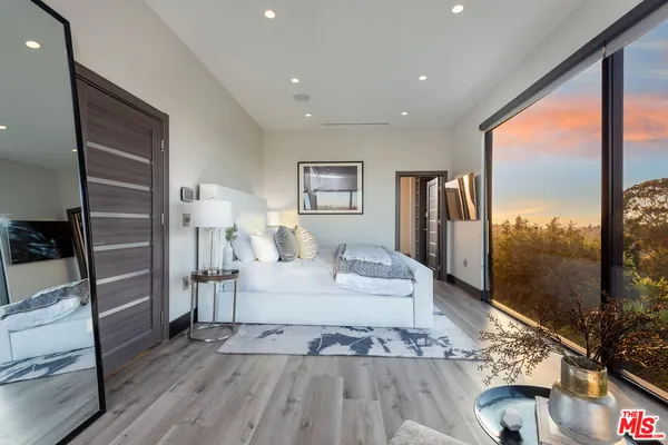 a large bedroom with a large bed and a large window