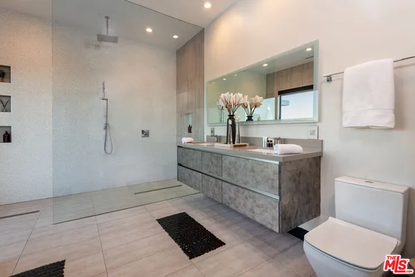 a kitchen with stainless steel appliances a stove a sink and a refrigerator