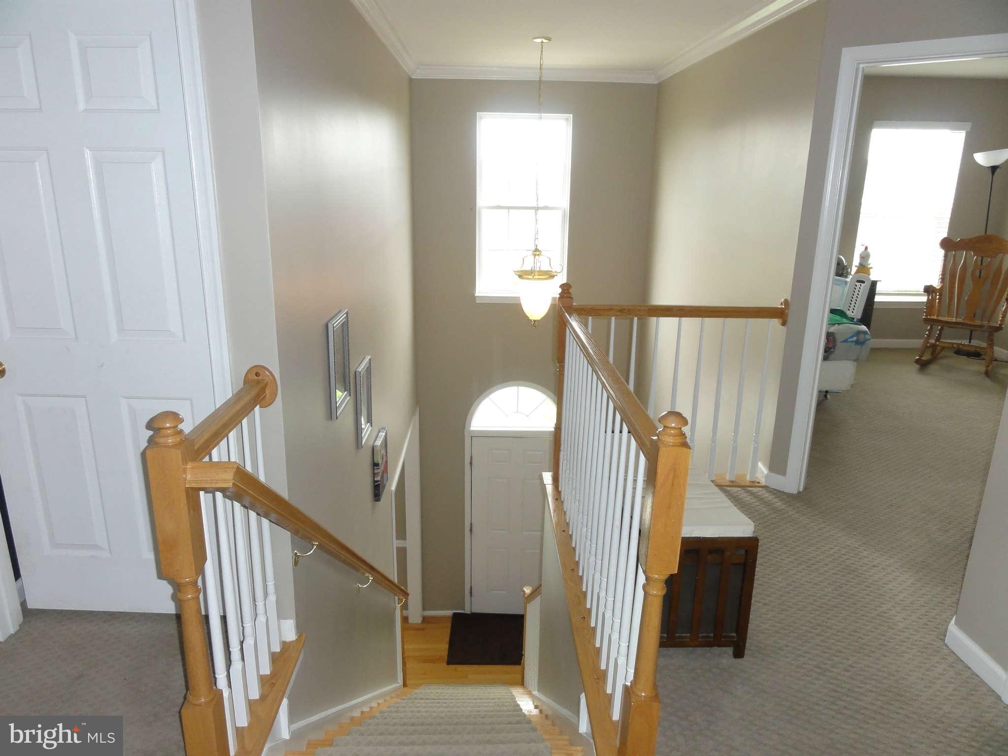 1341 Stallion Street Ranson, WV 25438 - Photo 22 of 27 a view of a staircase with wooden floor and a chandelier