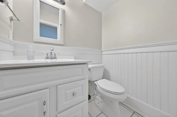 a bathroom with a toilet a sink and a mirror