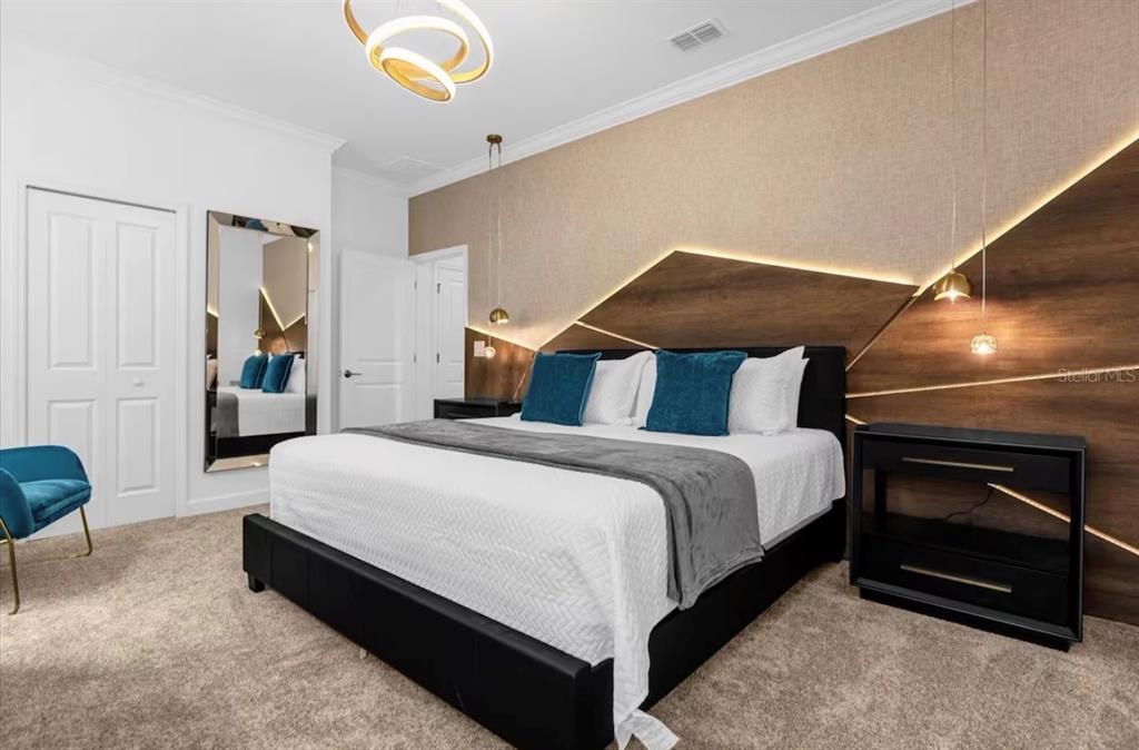 2992 Penelope Loop Kissimmee, FL 34746 - Photo 22 of 83 a bedroom with a bed and a couch