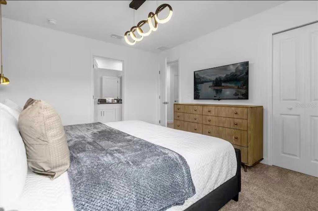 2992 Penelope Loop Kissimmee, FL 34746 - Photo 37 of 83 a bedroom with a bed and a television